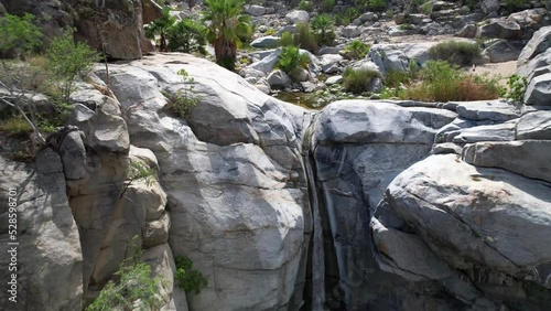 tropical waterfall cobo san lucus mexico with giant rocks desert and forest surrounding it photo