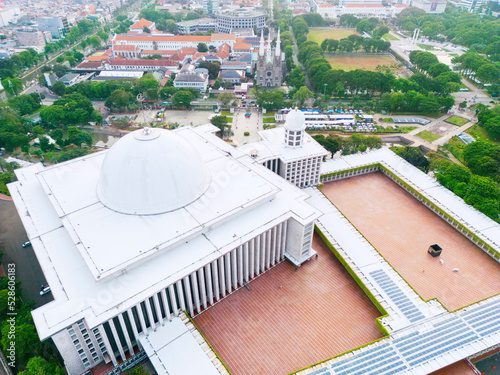 Beautiful Istiqlal mosque with church in Jakarta city photo