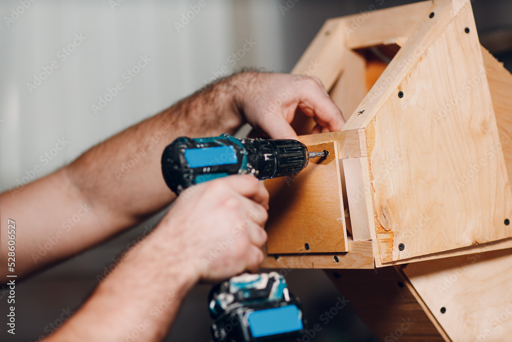 Artisan craftsman carpenter sculptor frame wooden create carcass framework. Wooden board, plywood and screwdriver Artisan craftsman carpenter sculptor frame wooden create carcass framework. Wooden board, plywood and screwdriver