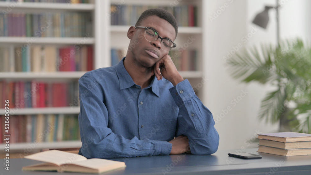 Sleepy Young African Man Taking Nap While Sitting in Office Sleepy Young African Man Taking Nap While Sitting in Office