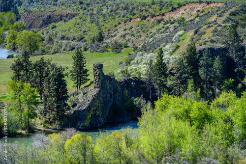 Scenic view of the Yakima River Valley with a chimney rock formation alongside the Yakima River, sunny spring day in Kittitas County, Eastern Washington State
 photo