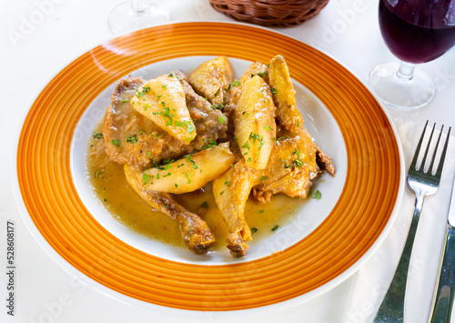 Picante de pollo, baked chicken with pears and spicy sauce made of sparkling wine with cinnamon, popular dish of bolivian cuisine