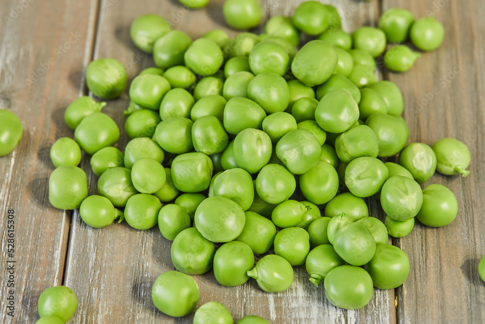 Fresh green peas heap on wooden background Fresh green peas heap on wooden background