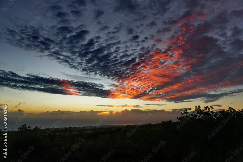 Sunset with orange stripped clouds in Kauai Hawaii
