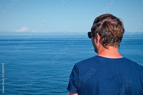 Mature man standing on the deck of the ferry