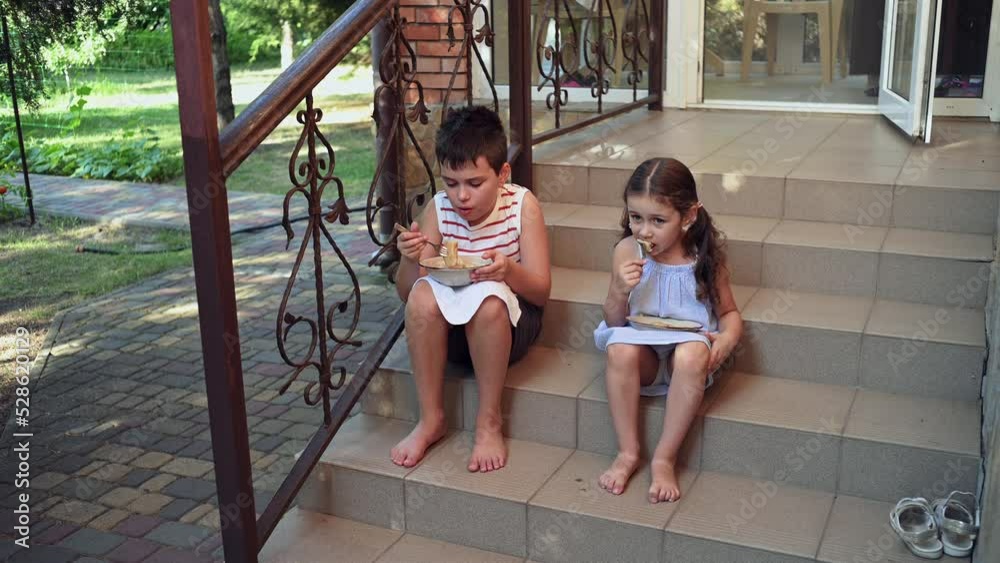 Adorable European children in summer wear, teenage boy and preschool