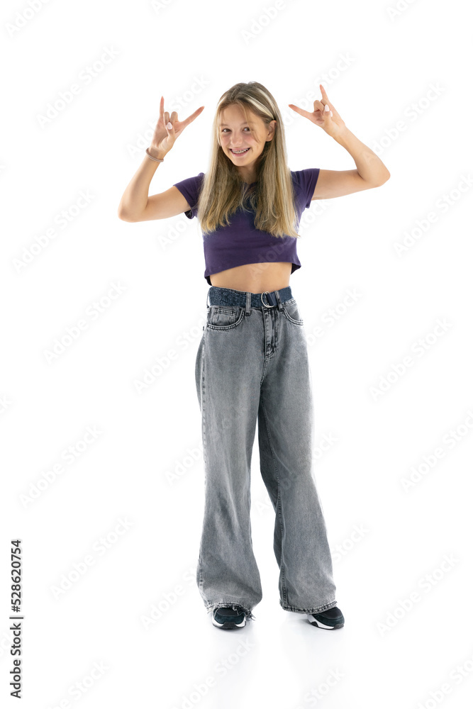 Full length portrait of pretty girl showing rock gesture with hands isolated on white background. Teen woman looking to the camera. Beautiful female smile with braces. Full length portrait of pretty girl showing rock gesture with hands isolated on white background. Teen woman looking to the camera. Beautiful female smile with braces.