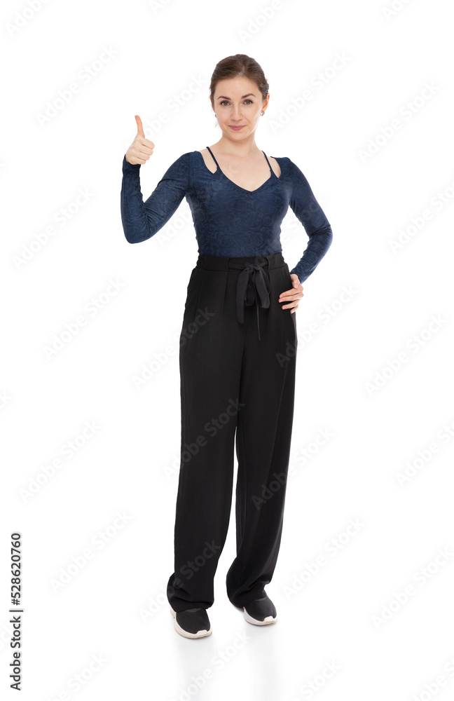 Full length studio portrait of pretty girl isolated on white background. Young woman showing thumbs up gesture and looking to the camera. Full length studio portrait of pretty girl isolated on white background. Young woman showing thumbs up gesture and looking to the camera.