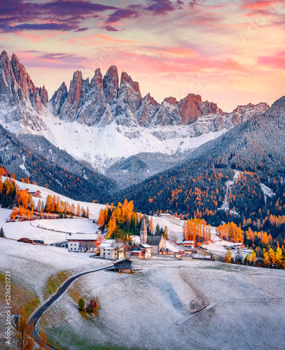 Fototapeta Naklejka Na Ścianę i Meble -  Fresh snow covered green hills on Santa Magdalena village. Fantastic autumn view of Seceda peak. Incredible landscape of Dolomite Alps, Italy. Traveling concept background.