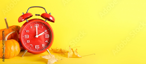 Alarm clock and autumn leav...