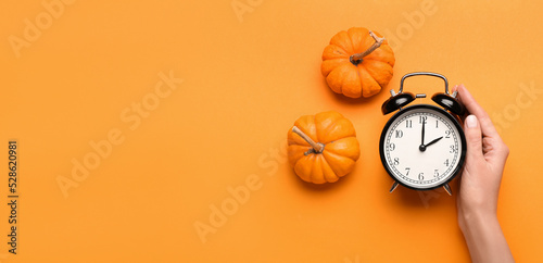 Female hand with alarm cloc...