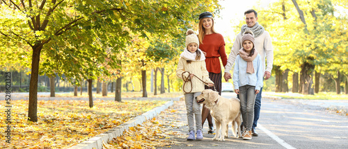 Happy young family with dog...