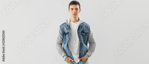 Teenage boy in stylish clothes on light background