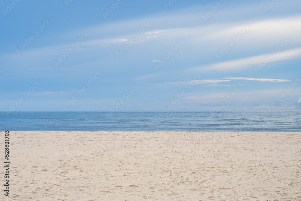 Beautiful white sand beach, turquoise ocean water and blue sky with clouds in sunny day. copyspace for text on the right side Tropical sea and relax on holiday travel vacation concept.