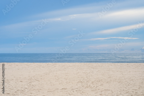 Beautiful white sand beach  turquoise ocean water and blue sky with clouds in sunny day. copyspace for text on the right side Tropical sea and relax on holiday travel vacation concept.
