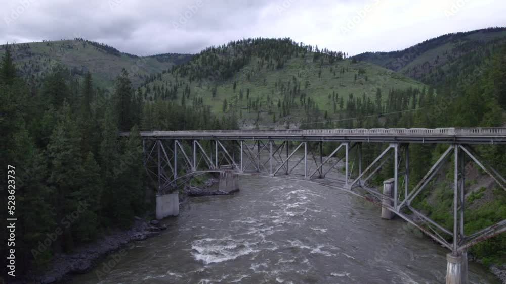 View on old bridge in mountains place. Mountain river flowing under bridge.
