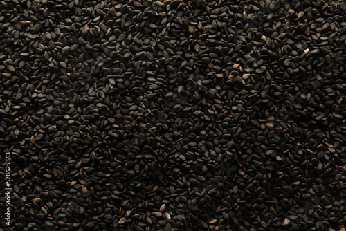 Black sesame seeds as background, closeup