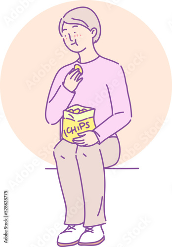 Cute girl student eating fast food chips during break.