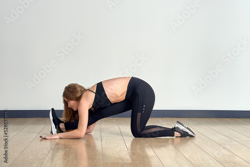 Young beautiful woman in the gym doing yoga