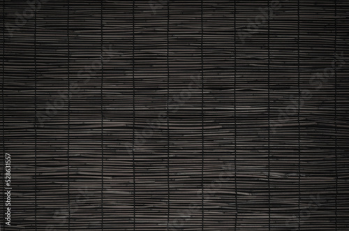 Close up of black bamboo screen. Blind made of split bamboo or reeds fastened together with thread.