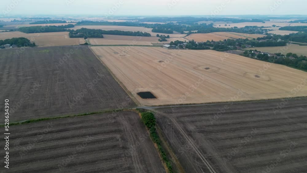Drone flyover of fields with vehicle tracks and a scorch mark Drone flyover of fields with vehicle tracks and a scorch mark