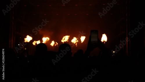 DJ concert pyrotechnic showcase of multiple bursts of flames and flashing lights photo
