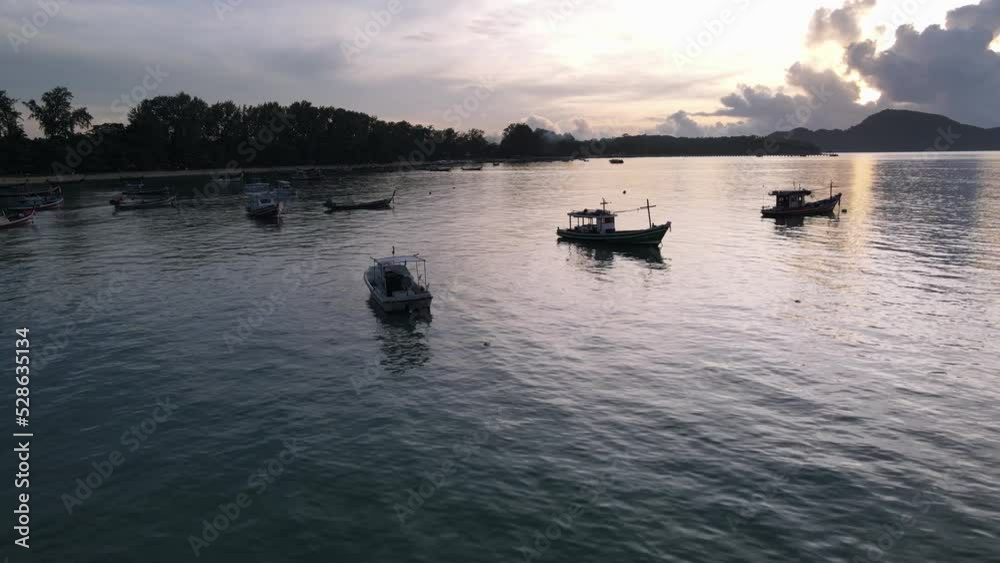Drone aerial slow move parallax over tropical blue water during sunrise with thai speedboats around Drone aerial slow move parallax over tropical blue water during sunrise with thai speedboats around