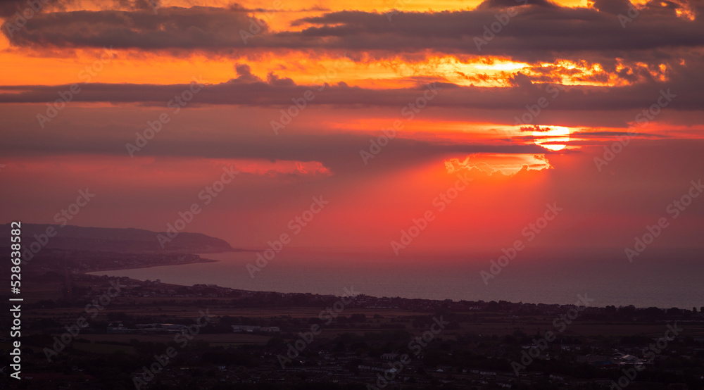 Brilliant September sunrise from Butts Brow looking east along the coast to Hastings East Sussex south east England UK