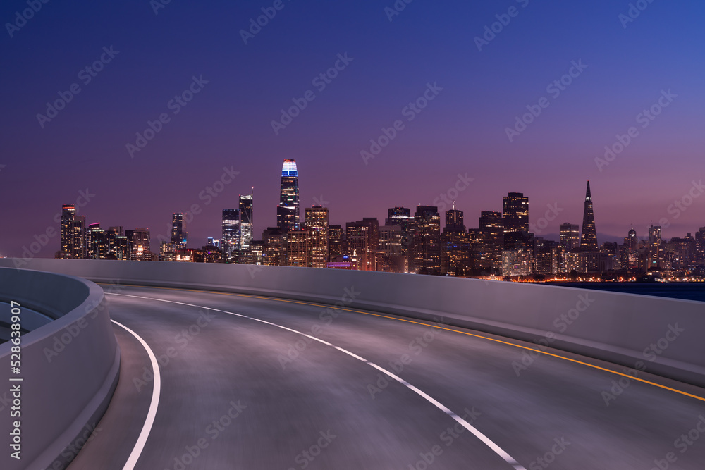 Obraz premium Empty urban asphalt road exterior with city buildings background. New modern highway concrete construction. Concept way to success. Transportation logistic industry fast delivery. San Francisco. USA.