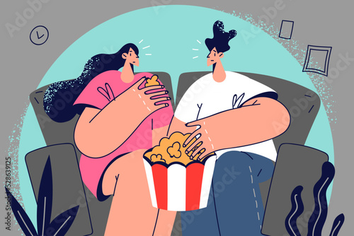Happy couple watching movie eating popcorn 