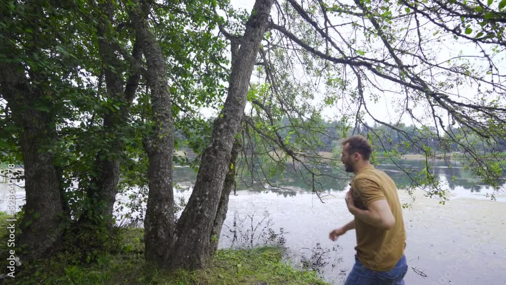 Young man experiencing heartache.
Man experiencing heartache while walking in the forest leans against a tree.
Young man experiencing heartache.
Man experiencing heartache while walking in the forest leans against a tree.