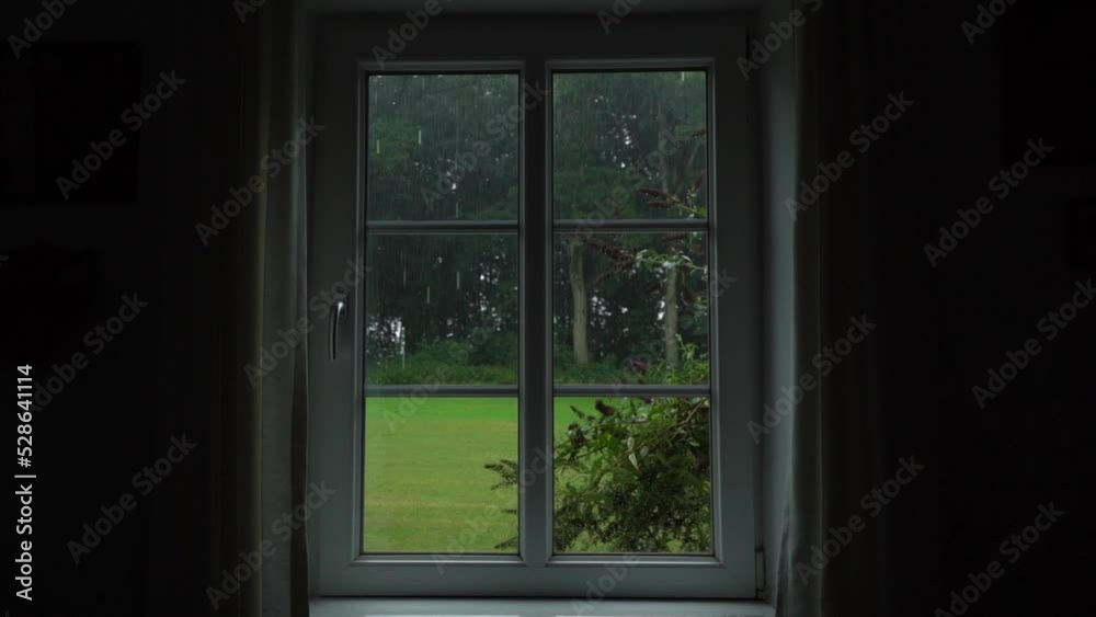 Rain Pouring Down In The Yard Seen Through The Window. - POV