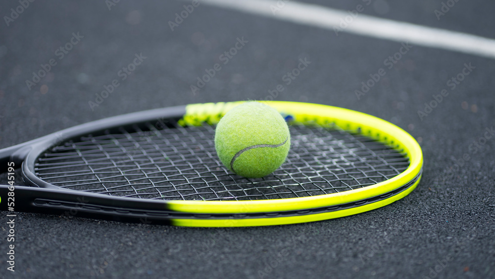 Tennis racket and tennis ball. Image with selective focus