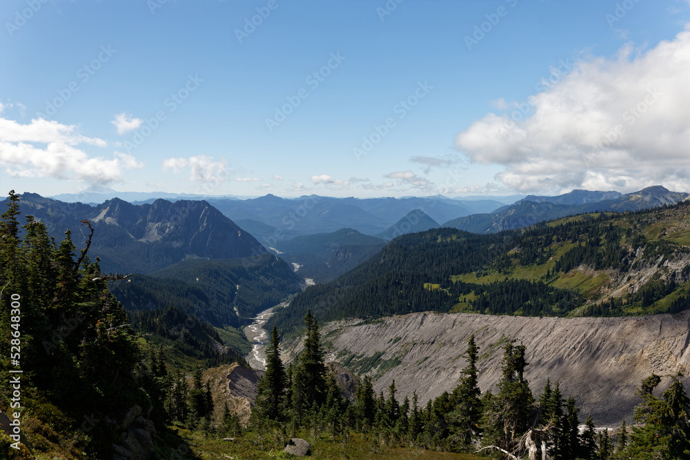The Nisqually River flowing through a valley in the mountains surrounding Mt. Rainier National Park.