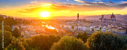 Panoramic view of Arno river, with Ponte Vecchio, Palazzo Vecchio and Cathedral of Santa Maria del Fiore during sunset, Florence, Italy
