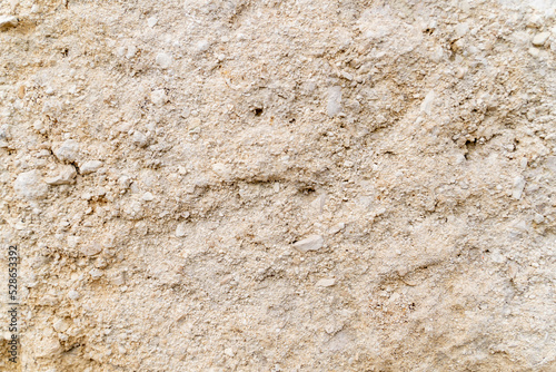 Beige stone wall background. The texture of the stone.