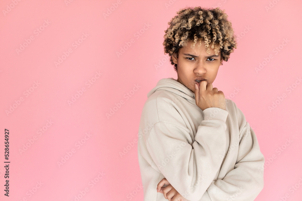 Mistrustful African American woman. Female model in glasses with curly hair thinking. Portrait, studio shot, emotion concept Mistrustful African American woman. Female model in glasses with curly hair thinking. Portrait, studio shot, emotion concept