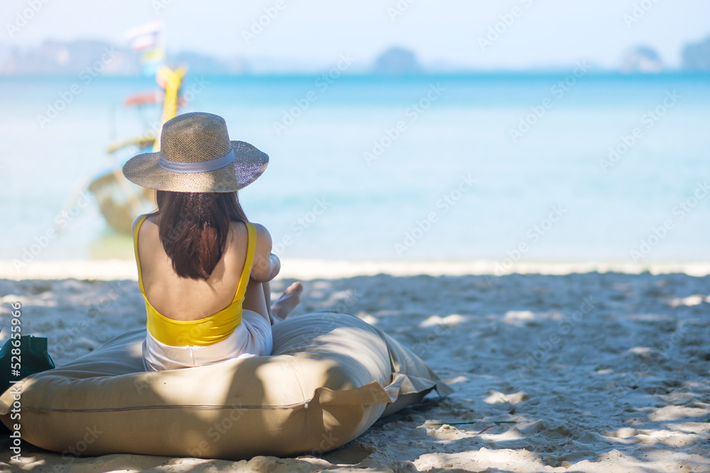 Obraz premium Woman tourist rest on Beautiful beach Island at summer. destination, wanderlust, Asia Travel, tropical summer, vacation and holiday concept