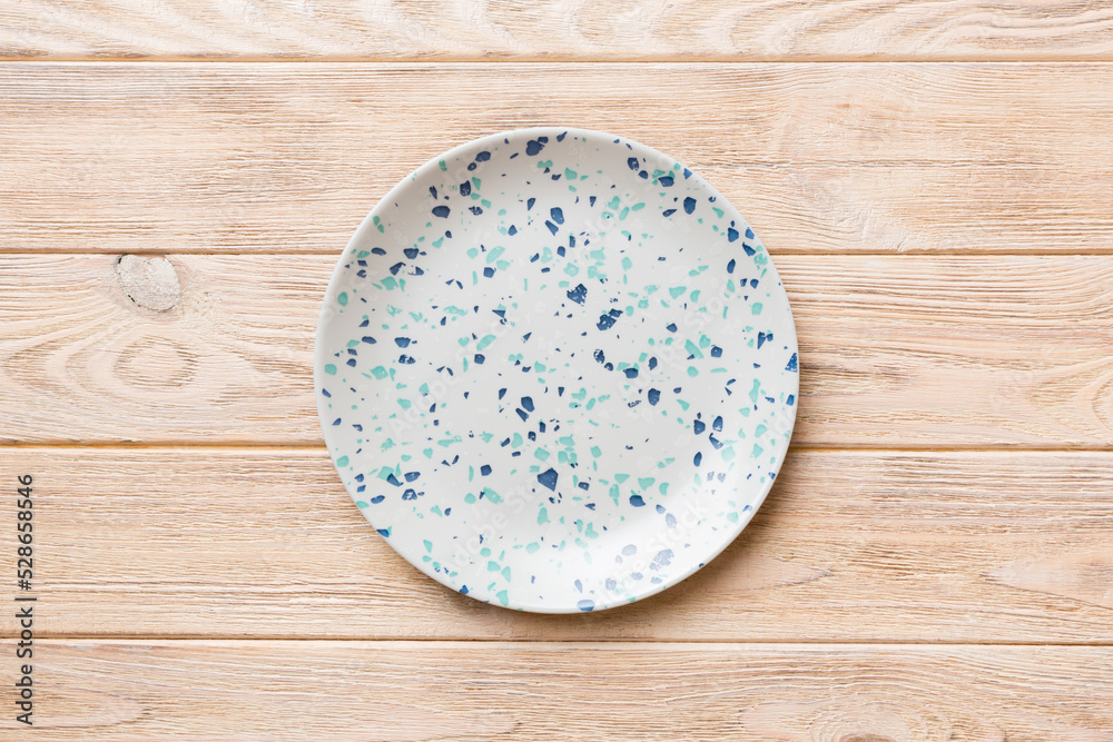 Top view of empty blue plate on wooden background. Empty space for your design Top view of empty blue plate on wooden background. Empty space for your design