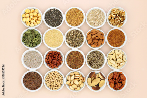 Health food collection high in lipids. Ingredients contain unsaturated good fats for healthy heart and cholesterol levels with nuts, seeds, legumes and grain. On neutral background.