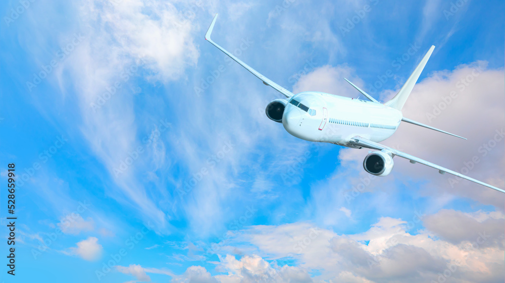 Obraz premium White passenger airplane flying in the sky amazing clouds in the background - Travel by air transport