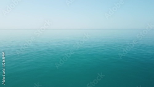 Wallpaper Mural Aerial view from above on calm azure sea and volcanic rocky shores. Small waves on water surface in motion blur. Nature summer ocean sea beach background. Nobody. Holiday, vacation and travel concept Torontodigital.ca