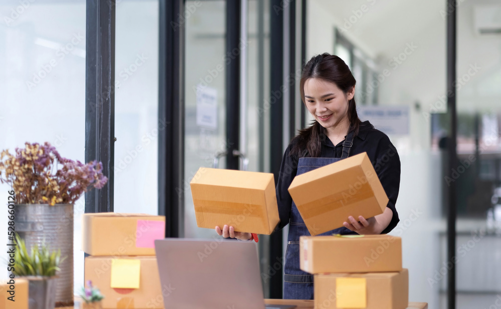 Startup small business SME, Entrepreneur owner checking online purchase shopping order to preparing pack product box. Selling online ideas concept Startup small business SME, Entrepreneur owner checking online purchase shopping order to preparing pack product box. Selling online ideas concept