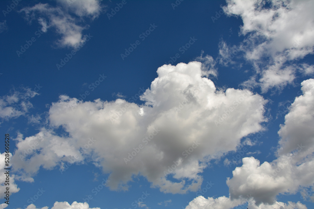 Fototapeta premium White, fluffy clouds in blue sky. Background from clouds.