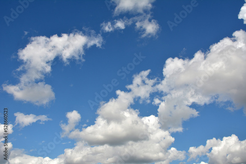 White  fluffy clouds in blue sky. Background from clouds.