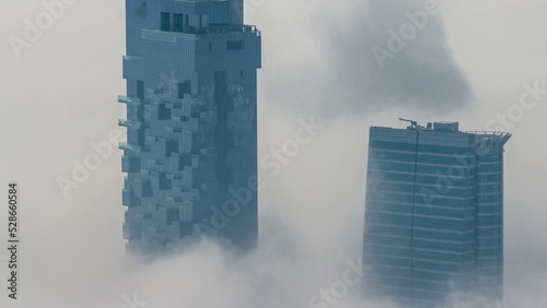 Fog covered JLT skyscrapers and marina towers near Sheikh Zayed Road aerial timelapse during sunrise. Residential buildings
