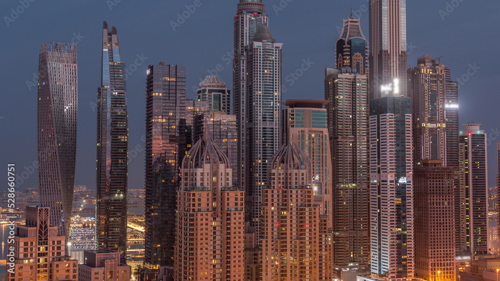 Skyscrapers of Dubai Marina near intersection on Sheikh Zayed Road with highest residential buildings night to day timelapse