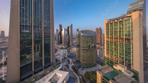 Dubai international financial center skyscrapers with promenade on a gate avenue aerial all day timelapse.