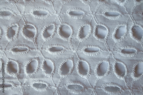 Macro of vintage white eyelet embroidery cotton fabric