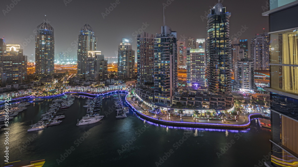 Panorama showing luxury yacht bay in the city aerial night timelapse in Dubai marina